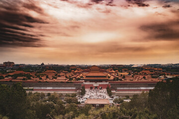 A view over forbidden city in bejing china. From the top of the hill in Jingshan park. Sunset in...