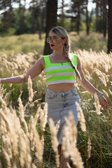 Portrait of a girl in a meadow of yellow spikelets