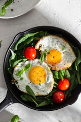 Breakfast with ried eggs on a pan