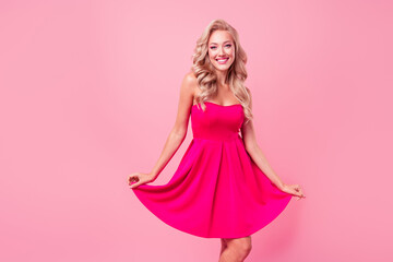 Photo of cute cheerful lovely girl toothy smile have good mood arms hold dress dancing isolated on pink color background - Powered by Adobe