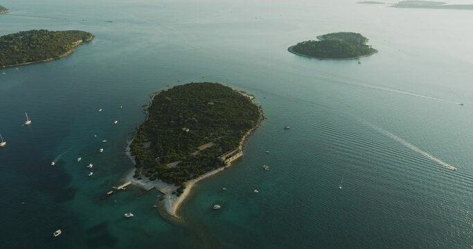 Aerial view of sailboat moored along Kotez Island at Brijuni National Park, a group of islands along the Adriatic Sea coastline near Pula, Istria, Croatia.