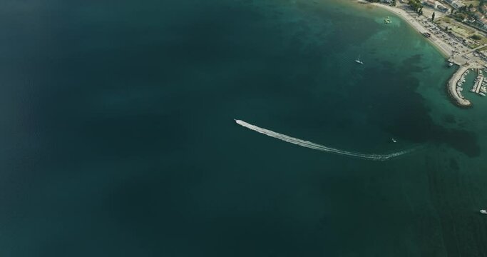 Aerial view of a speedboat sailing along the Adriatic Sea coastline near Pula, Istria, Croatia.