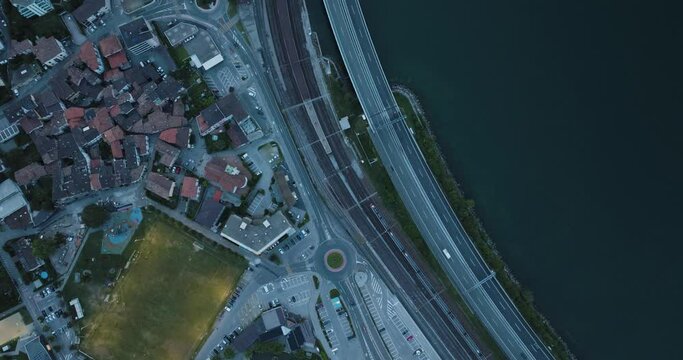 Aerial view of a road and a railway following the Lugano Lake coastline in Melide, Ticino, Switzerland.