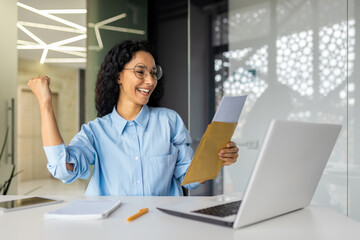 Successful and happy business woman at workplace received envelope mail fox, Hispanic woman...