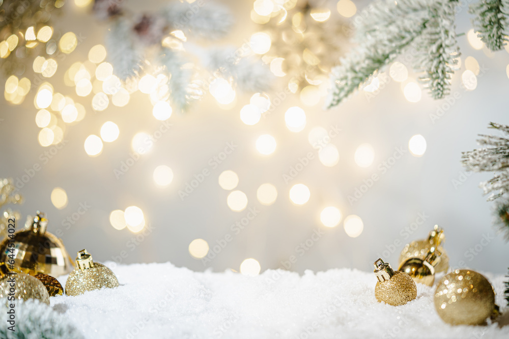 Wall mural christmas holiday background with snow, fir tree and decorations with christmas light behind