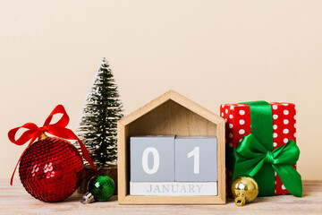 25 december. Christmas composition on colored background with a wooden calendar, with a gift box,...