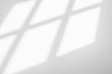 Abstract light reflection and grey shadow from window on white wall background. Gray window shadows and sunshine stripe diagonal geometric overlay effect for backdrop and mockup design