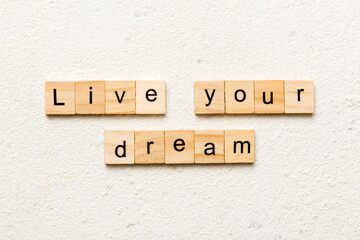 live your dream word written on wood block. live your dream text on cement table for your desing, concept