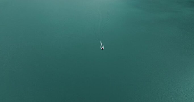 Aerial view of a boat sailing across the Brienzersee Lake in summertime, Bonigen, Bern, Switzerland.