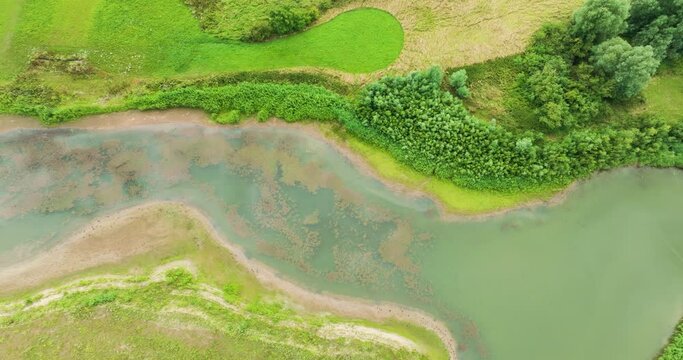 Abstract aerial view straight down of water strip in nature development area Lunenburgerwaard, Amerongen, Utrecht, Netherlands
