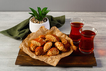Traditional Turkish sweets and tea on wooden background. Selective focus.