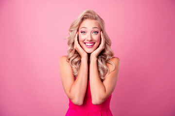 Photo of overjoyed adorable shiny lady impressed unexpected gift rejoice theme party isolated on pink color background