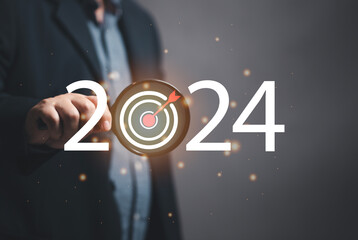 Marketer holding a magnifying glass to focus on marketing goals for 2024, setting marketing goals for next year. organization growth Setting guidelines for doing business. Marketing strategy and goal.