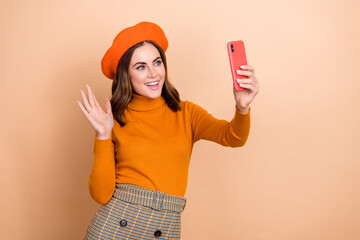 Portrait of gorgeous cheerful person hold telephone make selfie arm palm waving hi isolated on...