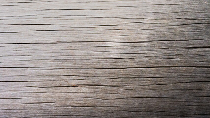 Fototapeta premium The texture, rough, and patterned, is characteristic of wooden planks, in rural areas.