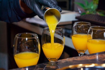 Alcoholic drink made with orange juice and champagne called Mimosa, a space for celebration and joy. - 644532023