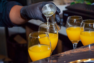 Alcoholic drink made with orange juice and champagne called Mimosa, a space for celebration and joy. - 644532234