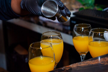 Alcoholic drink made with orange juice and champagne called Mimosa, a space for celebration and joy. - 644532239