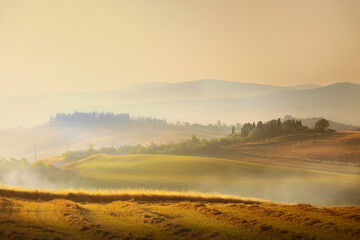 Impressive panorama Italian landscape, view with cypress trees, vineyards and farmer's fields. Tuscany, Italy