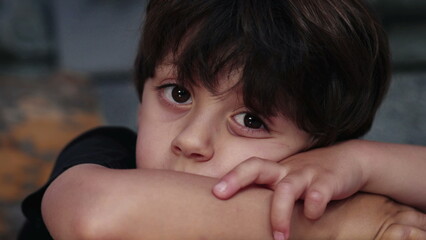 Contemplative Wonder of Pensive Small Boy Lost in Thought, Gazing into the Distance with...