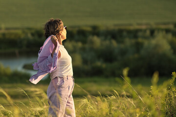 An elderly woman in fashionable clothes enjoying a serene day outdoors, symbolizing the peace of mind financial planning can bring