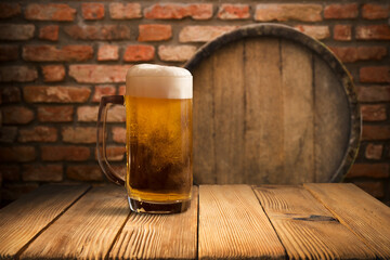 mug of beer, wheat ears, green hops and beer barrel on a wooden background. High quality photo