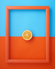 Orange in frame on blue and orange background