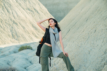 beautiful woman taking a break during mountain hiking looking away