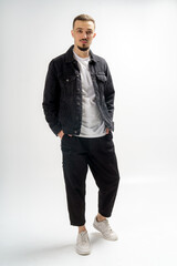 Young handsome guy on a gray studio background