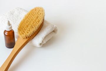 Massage and bath brush with cosmetic oil. Spa set concept