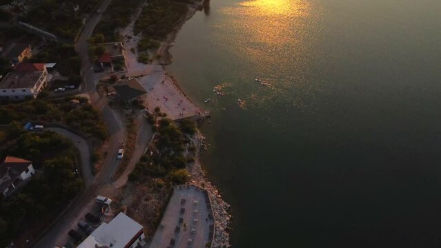Aerial drone view of Shiroka Lake at sunset near Shkoder. Albania. Overhead plan with the entire recreational area and beaches