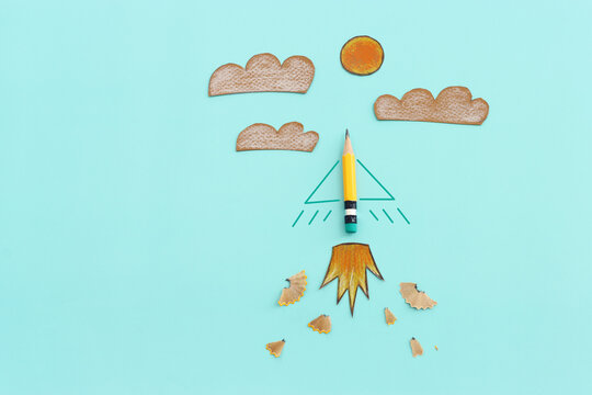 Concept image of pencil as rocket metaphor on blue background