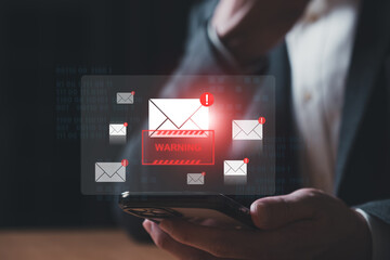Business man using smartphone and computer that show warning sign after got attack phishing email by malware from hacker that commit cyber crime or software crash to cause an error.