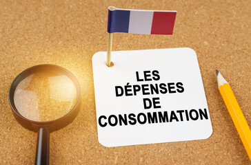 On the table is the flag of France and a sheet of paper with the inscription - Consumer spending