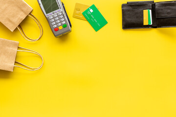 Retail and shopping concept. Pos payment terminal with credit cards and shopping bags