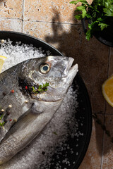 Cooking fresh dorado fish with salt and lemon