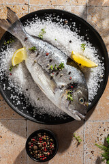 Cooking fresh dorado fish with salt and lemon