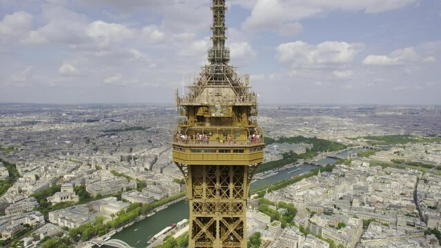 Aerial view of the observation deck at the top of the Eiffel Tower, 276 meters high, in Paris, France. Cinematic 4k.