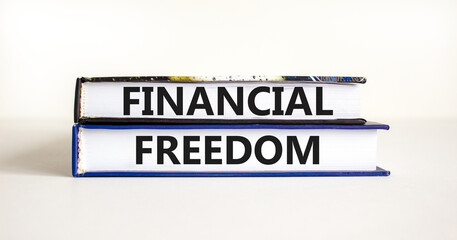 Financial freedom symbol. Concept words Financial freedom on beautiful books. Beautiful white table white background. Business financial freedom concept. Copy space.