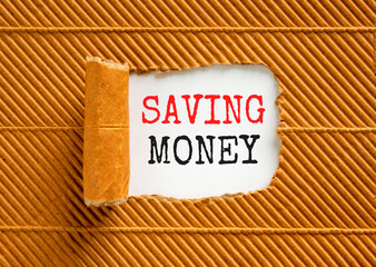 Saving money symbol. Concept words Saving money on beautiful white paper on a beautiful brown paper background. Business, support and saving money concept. Copy space.