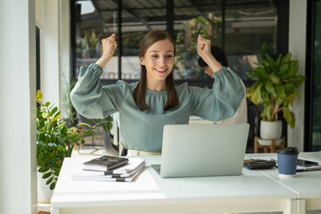 Overjoyed businesswoman happy for successful work.