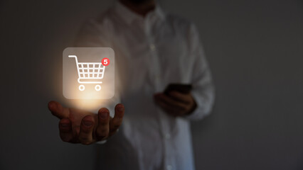 Red shopping baskets and parcel box with cart image on box float in the air above a smartphone for...