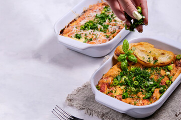 Oven baked frittata with mediterranen vegetables such as zucchini, tomatoes, bell peppers and red onions. Served in a rustic cast.Horizontal photo, space for text