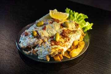 milanesa napolitana. typical argentinian meat in breadcrumbs.