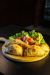 typical argentinian empanadas . large argentinian empanadas on black background