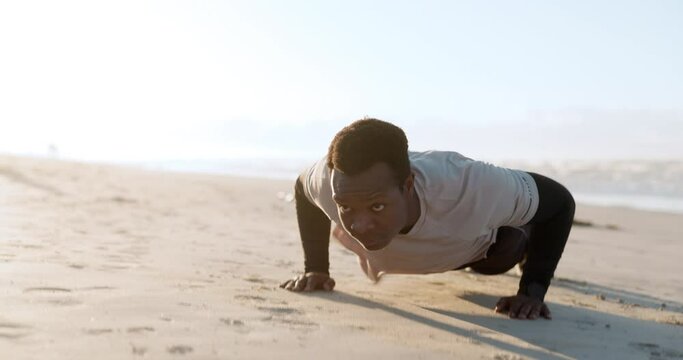 Black man, pushup and fitness exercise at beach, outdoor training and thinking with vision, goal or health. African guy, workout and wellness with ideas, strong or balance on sand, ocean and sunshine