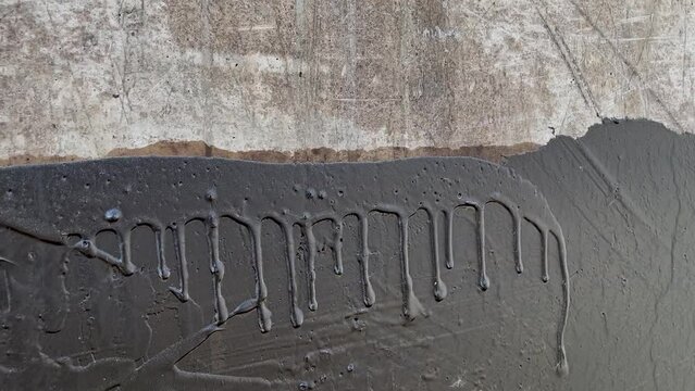 Waterproofing a concrete wall with liquid bitumen