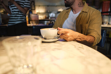 Fototapeta na wymiar Young man drinking coffee calmly
