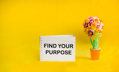 Notepad on a yellow background with the inscription FIND YOUR PURPOSE.