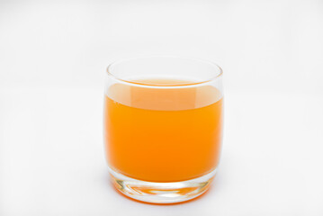 Glass glasses with orange juice on a white background. Delicious orange cooling drink.